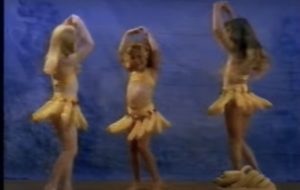 Little girls dancing with bananas.