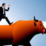 businessman riding a bull