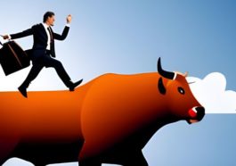 businessman riding a bull