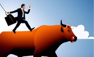 businessman riding a bull