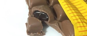 a broken piece of vegemite cadbury chooolate