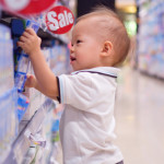 child taking item off store shelf