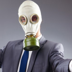 man with gasmask holding apple