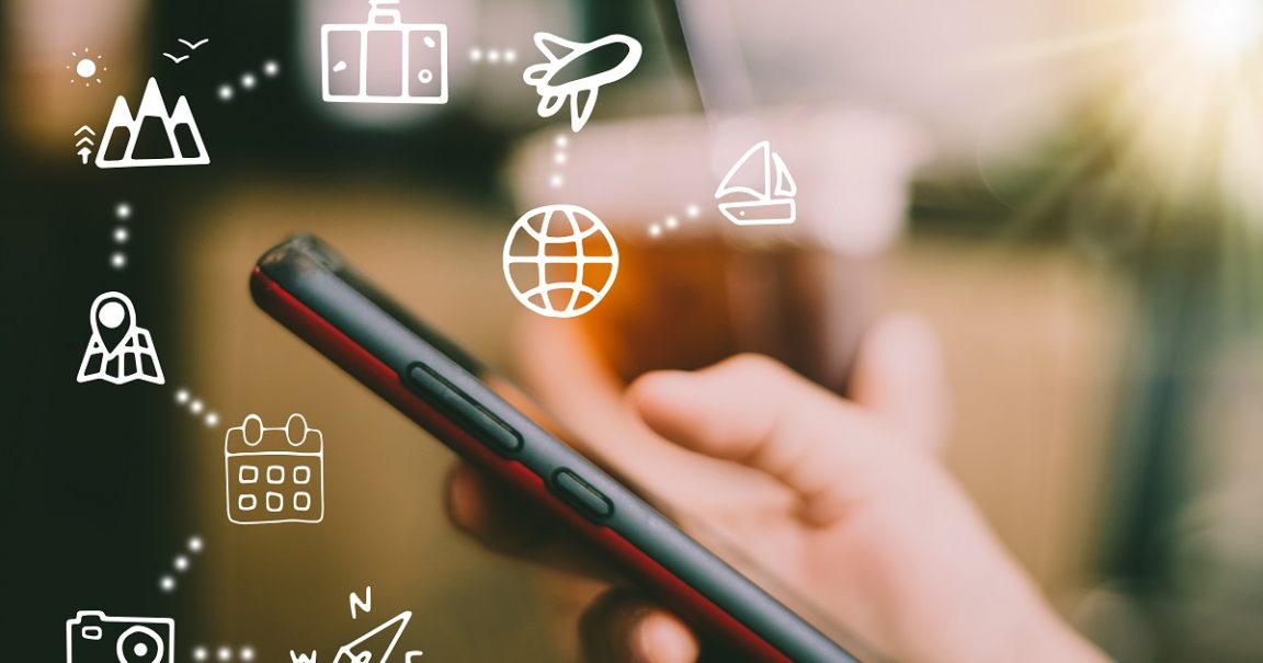 Travel vacation icons mixed screen on woman hand using smartphon