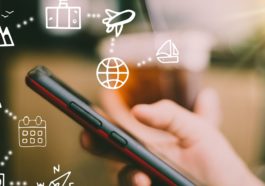 Travel vacation icons mixed screen on woman hand using smartphon