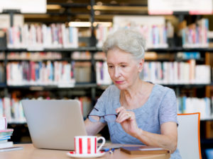 Elderly lady working with laptop