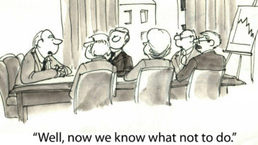 Cartoon with a board meeting and someone saying "Well, now we know what not to do"