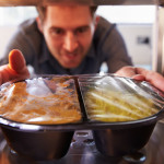 man removing microwaved meal from microwave