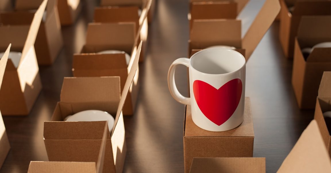 warehouse of white mugs with a heart in cardboard boxes.