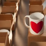 warehouse of white mugs with a heart in cardboard boxes.