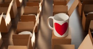 warehouse of white mugs with a heart in cardboard boxes.