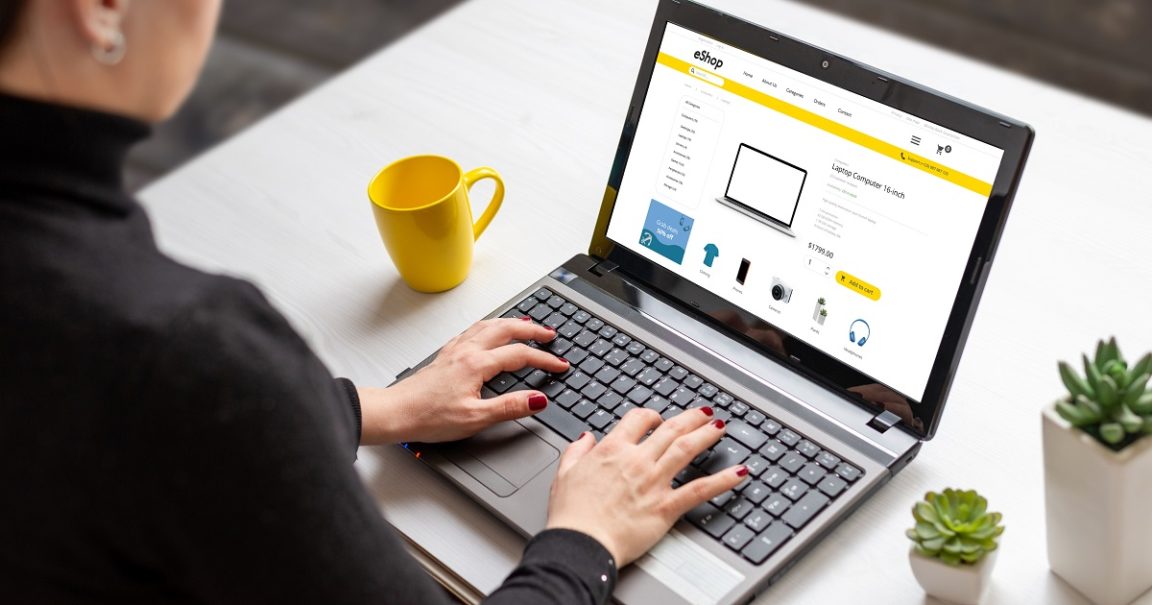 Woman shopping online with laptop computer from home. Modern flat design e-commerce web site with technology products