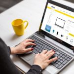 Woman shopping online with laptop computer from home. Modern flat design e-commerce web site with technology products