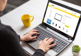 Woman shopping online with laptop computer from home. Modern flat design e-commerce web site with technology products