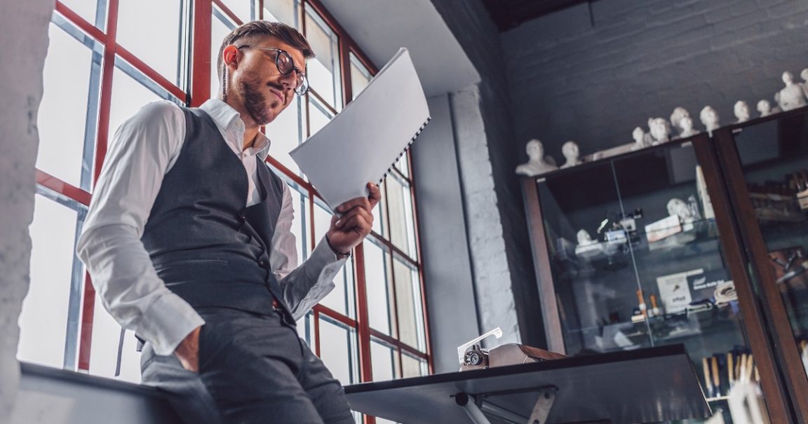 Young man with a screenplay in the office